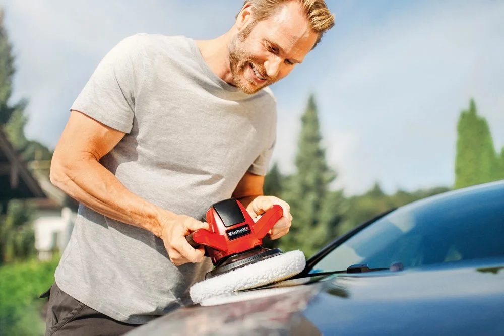 Person poliert Auto